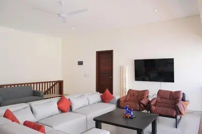 a living room with a couch and chairs and a tv at 5beds, 10 ppl, 10mins to beach, Private Pool in Sanur