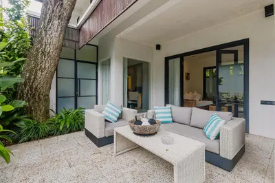 a patio with a couch and a table at Luxury with A Soul - Martini 2 1BR Villa Reimagined in Kerobokan