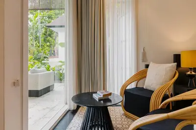 a living room with a chair and a table at Luxury with A Soul - Martini 2 1BR Villa Reimagined in Kerobokan