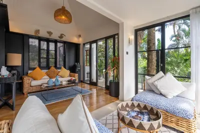 a living room with a couch and a table at Walk into Serenity, Martini 3 - 1BR Treetop Villa in Kerobokan