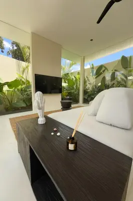 a bedroom with a bed and a large window at Villa Kina - Tropical 2BR Villa with Pool and Billiard in Seminyak