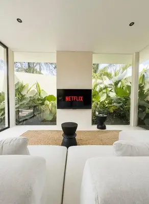 a bedroom with two beds and a sign that reads netflix at Villa Kina - Tropical 2BR Villa with Pool and Billiard in Seminyak