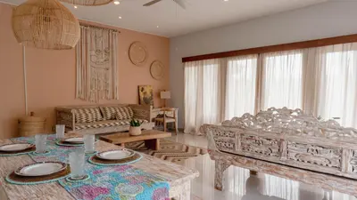 a living room with a table and a couch at 2 Bedroom Villa with Private Pool & Kitchen in Jimbaran
