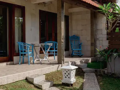two blue chairs and a table on a porch at 2 Bedroom Villa with Private Pool & Kitchen in Jimbaran