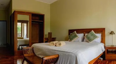 a bedroom with a bed with two towels on it at 2 Bedroom Villa with Private Pool & Kitchen in Jimbaran
