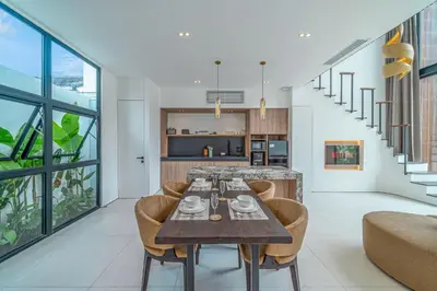 a dining room with a table and chairs at Hidden Elements in Canggu