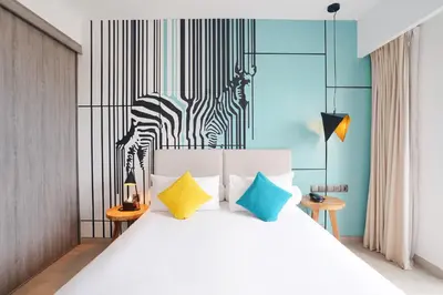 a bedroom with a bed with a zebra on the wall at Kamaniiya Petitenget Seminyak in Seminyak