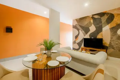 a living room with a table and a couch at Amelia D Art Deco Suites in Seminyak
