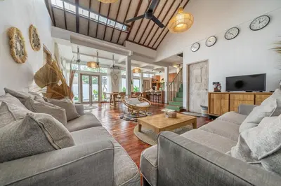a living room with two couches and a tv at Villa Arisanti in Kerobokan