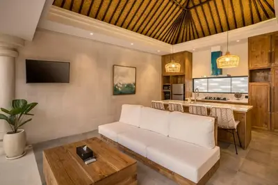 a living room with a white couch and a table at Priviere Seminyak - 2BR Villa with Pool Near Beach in Seminyak