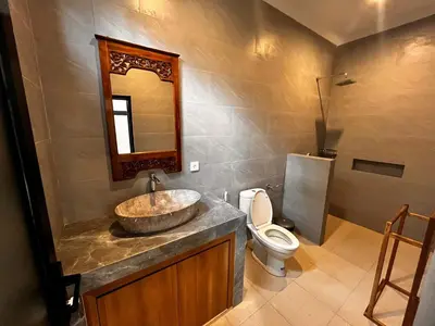 a bathroom with a sink and a toilet at BEN & B Villa 2 in Kerobokan