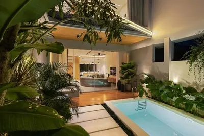 a house with a swimming pool with a lot of plants at Luxury Couple 2 BR Villa Umalas, Rooftop, Pool & View in Kerobokan