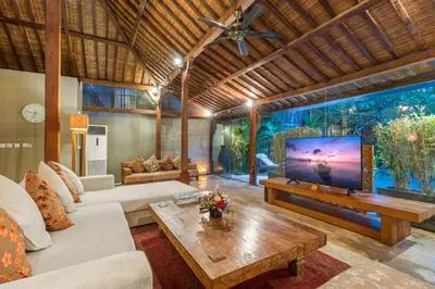 a living room with a large flat screen tv at Joglo-Style 3 Bedroom Villa in Heart Of Seminyak in Seminyak