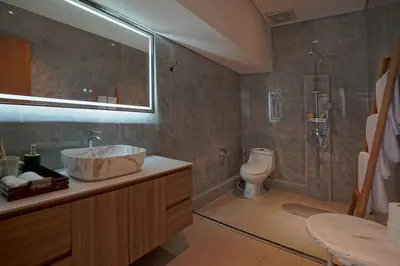 a bathroom with a sink and a shower and a toilet at Cleo Villa Padma Legian in Seminyak