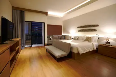 a large bedroom with a bed and a television at Cleo Villa Padma Legian in Seminyak