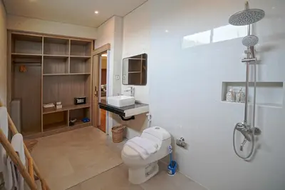 a bathroom with a toilet and a sink at Cleo Villa Padma Legian in Seminyak