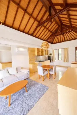 a living room with a couch and a table at Royal Tulip Springhill Resort Villa Kunyit 12 in Jimbaran