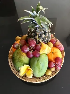 a basket of fruit with a pineapple and other fruits at Villa Aurikari in Legian