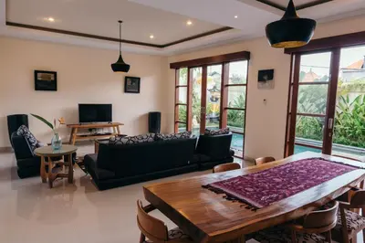 a living room with a table and a couch at Villa Aurikari in Legian