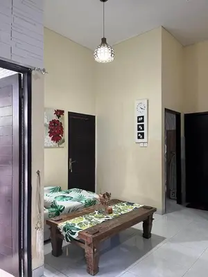 a living room with a table and a couch at 2 Bedroom Guest House Near Jimbaran Beach in Jimbaran