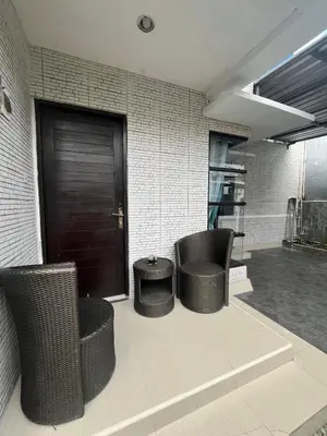 a lobby with two chairs and a table and a door at 2 Bedroom Guest House Near Jimbaran Beach in Jimbaran