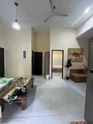 a large living room with a couch and a ceiling fan at 2 Bedroom Guest House Near Jimbaran Beach in Jimbaran