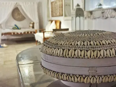 a room with a table with a room with a couch at Gypsy Boutique Villa in Seminyak
