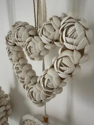 a wreath made out of shells hanging on a wall at Gypsy Boutique Villa in Seminyak