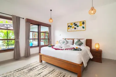 a bedroom with a bed and a window at Villa WENDY Mertanadi in Seminyak