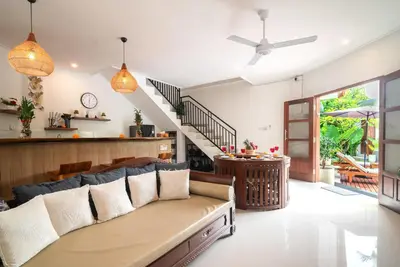 a living room with a couch and a table at Villa WENDY Mertanadi in Seminyak