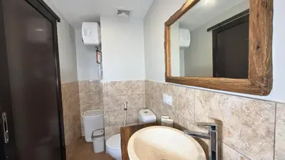 a bathroom with a sink and a mirror at Glory Rentals in Kuta