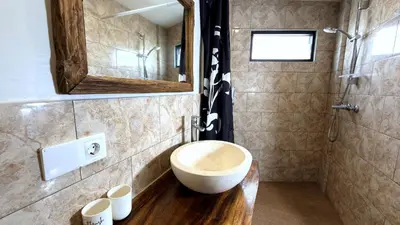 a bathroom with a large bowl sink in a shower at Glory Rentals in Kuta
