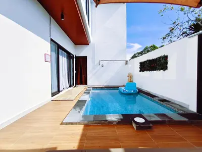 a swimming pool in the middle of a house at Joy Private Pool Villa in Kuta