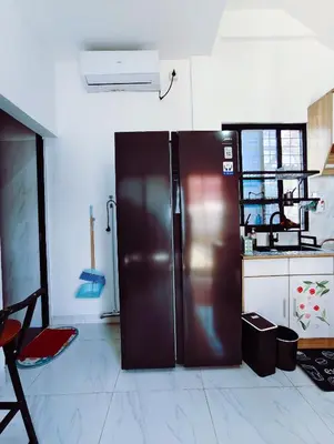 a kitchen with a stainless steel refrigerator in a room at Joy Private Pool Villa in Kuta