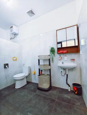 a bathroom with a toilet and a sink at Joy Private Pool Villa in Kuta