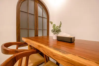 a wooden table with a box and a plant on it at Green Mutiara Jimbaran in Jimbaran