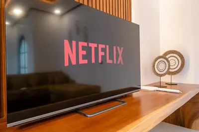 a netflix sign on a wall in a living room at Green Mutiara Jimbaran in Jimbaran
