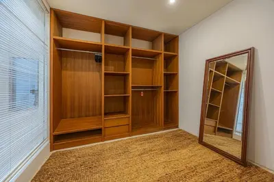 a closet with wooden shelves and a mirror in a room at Villa Arta - A Calm, Tropical Villa in Umalas in Canggu