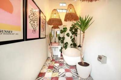 a hallway with two potted plants on a floor at Seminyak Beach Seagrass Villa 4BR - pool & staff in Seminyak