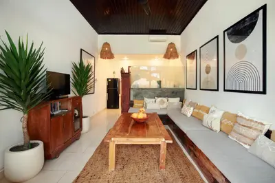 a living room with a couch and a coffee table at Seminyak Beach Seagrass Villa 4BR - pool & staff in Seminyak