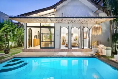 a swimming pool in front of a house at Villa Sobramesa Seminyak with pool, butler & parking in Seminyak