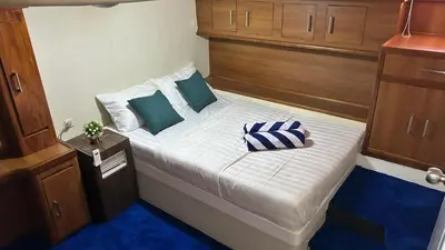a small bedroom with a bed on a boat at La Merry Yacht cruise in Pulau Serangan