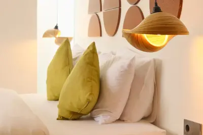 a group of pillows on a couch with a lamp at Glenda Cozy 3 BR Private Pool Villa in Canggu
