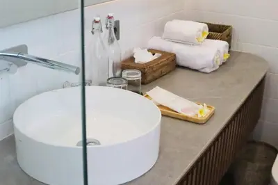 a bathroom with a sink and a bath tub at Glenda Cozy 3 BR Private Pool Villa in Canggu