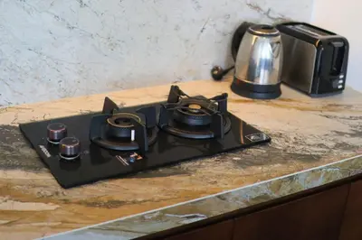 a black stove top sitting on top of a counter at Glenda Cozy 3 BR Private Pool Villa in Canggu