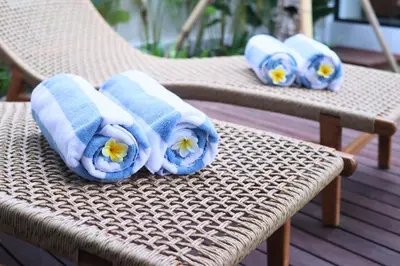a group of towels sitting on a wicker chair at Rowena Comfortable 2 BR Private Pool Villa in Canggu