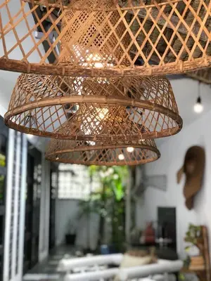 a wicker hanging light in a living room at 3BR Canggu Batu Belig Tropicana Villa - Walk to Beach in Canggu