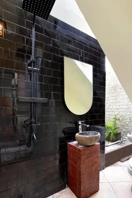 a bathroom with a sink and a mirror at WH18 Luxury Loft Villa with Pool & Office in Seminyak