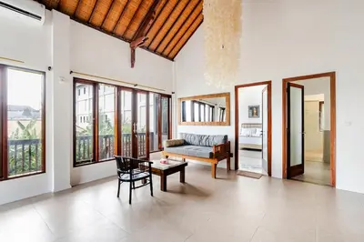 a living room with a couch and a table at iVAVev Isus Lucersfera in Seminyak
