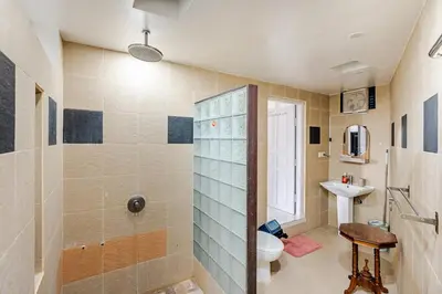 a bathroom with a shower and a toilet and a sink at iVAVev Isus Lucersfera in Seminyak